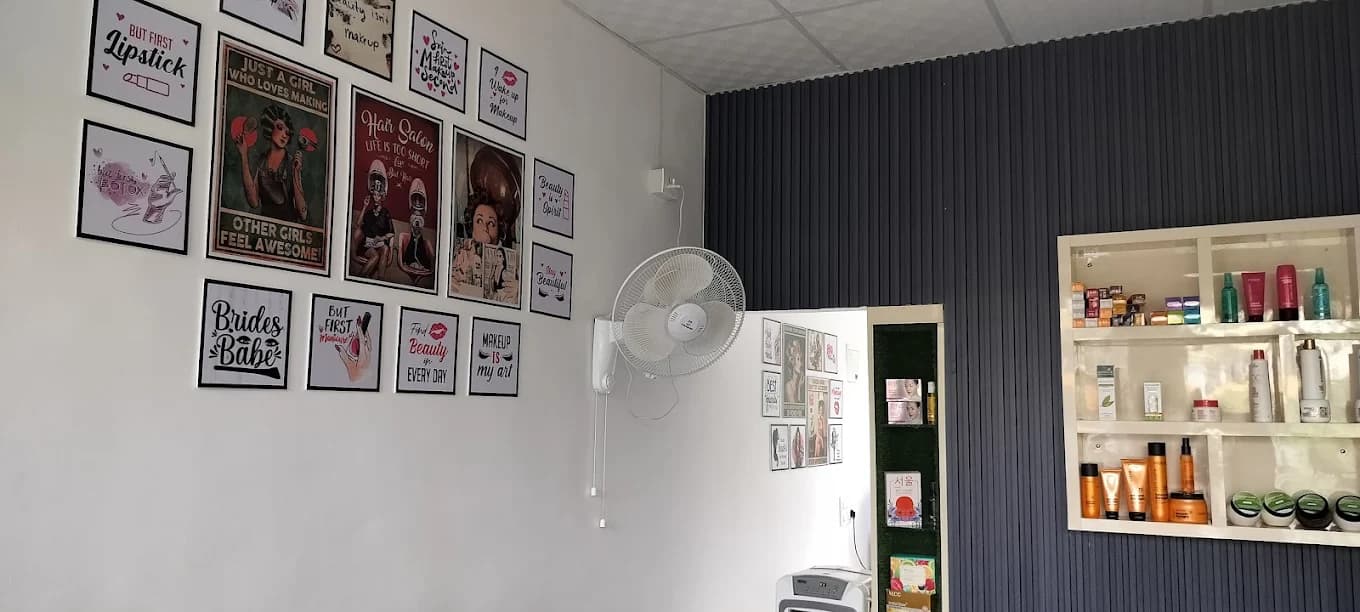 A wall of playful salon artwork and a product shelf inside Glow Studio